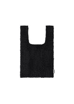 The MESH PLEATS BAG by HOMME PLISSÉ ISSEY MIYAKE is a black, textured rectangular knit bag with wide handles and a small white tag on the right side, showcasing a minimalist design and photographed against a white background. - BLACK （no.15）