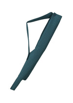 The UMBRELLA PLEATS BAG by HOMME PLISSÉ ISSEY MIYAKE, featuring dark teal pleats and a shoulder strap, is displayed against a white background.