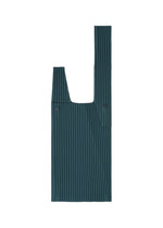 The UMBRELLA PLEATS BAG by HOMME PLISSÉ ISSEY MIYAKE is a dark green, rectangular reusable handbag featuring vertical pleats, two handles, button details, and an integrated umbrella holder—shown flat against a white background.