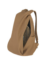 The PLEATS BACKPACK by HOMME PLISSÉ ISSEY MIYAKE features a tan pleated design, unique texture, adjustable straps, and is shown partially unzipped to reveal an interior pocket and beige pouch.