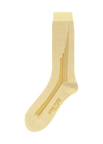 The RAY SOCKS by HOMME PLISSÉ ISSEY MIYAKE feature a single beige design with yellow accents, including multiple parallel yellow stripes on the side and the brand’s name written near the toe area, offering a subtle ray pattern socks aesthetic to your look. - YELLOW BEIGE （no.56）