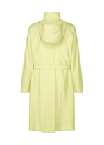 The OPACITY coat by HOMME PLISSÉ ISSEY MIYAKE is a light yellow, knee-length garment featuring long sleeves, a matching belt, and a detachable hood. Crafted from a durable nylon linen blend, it is shown from the back against a white background.