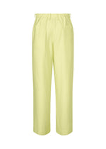OPACITY high-waisted pants by HOMME PLISSÉ ISSEY MIYAKE in light yellow, crafted from a linen blend with a loose fit, elastic waistband, and straight legs, displayed against a white background.
