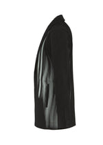 The IN THE SHADOW blazer by HOMME PLISSÉ ISSEY MIYAKE, a black pinstripe piece with optical-illusion stripe details, is shown in left side profile against a white background.