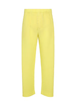 The SLASH pants by HOMME PLISSÉ ISSEY MIYAKE feature a yellow pleated design with straight-leg cut and subtle vertical ribbed texture, finished with an elastic drawcord waist for enhanced comfort. Displayed against a plain white background. - SHINE YELLOW （no.50）