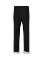 FRAMEWORK : CHUSEN by HOMME PLISSÉ ISSEY MIYAKE—black pleated straight pants with white side panels, elastic waistband, and inspired by the chusen Japanese dyeing technique. Shown front-facing on a white background.