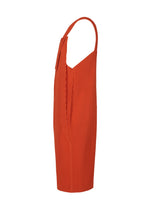 Side view of HOMME PLISSÉ ISSEY MIYAKE's PLEATS BOTTOMS 1 in orange, showcasing knee-length, pleated textured fabric, thin straps, loose straight fit with a slight v-neck, subtle side folds, and discreet pockets for practicality.