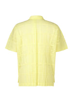 Back view of the LACE GRID PLEATS shirt by HOMME PLISSÉ ISSEY MIYAKE—a short-sleeve, light yellow open-collar piece with a relaxed fit, crafted from a cotton-blend polyester and featuring subtle vertical and horizontal grid patterns on its textured surface.
