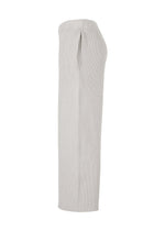Side view of the BASIC KNIT pants by HOMME PLISSÉ ISSEY MIYAKE—a pair of light beige, ribbed knit pants with a straight-leg silhouette and an elastic waistband, made from regenerated thread and shown against a white background.