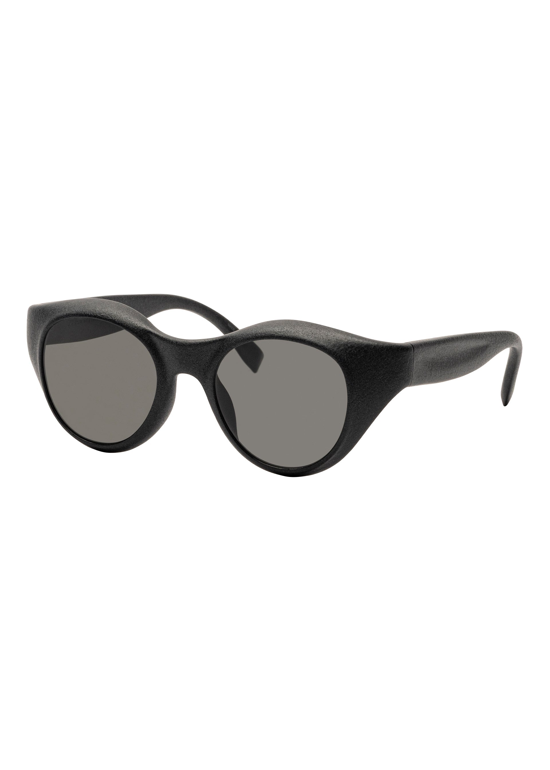 Zoomed view ISSEY MIYAKE EYES GRIT-BOSTON sunglasses feature thick, matte black Boston-style frames and dark tinted lenses, displayed at a slight angle on a white background. - - (no.13)