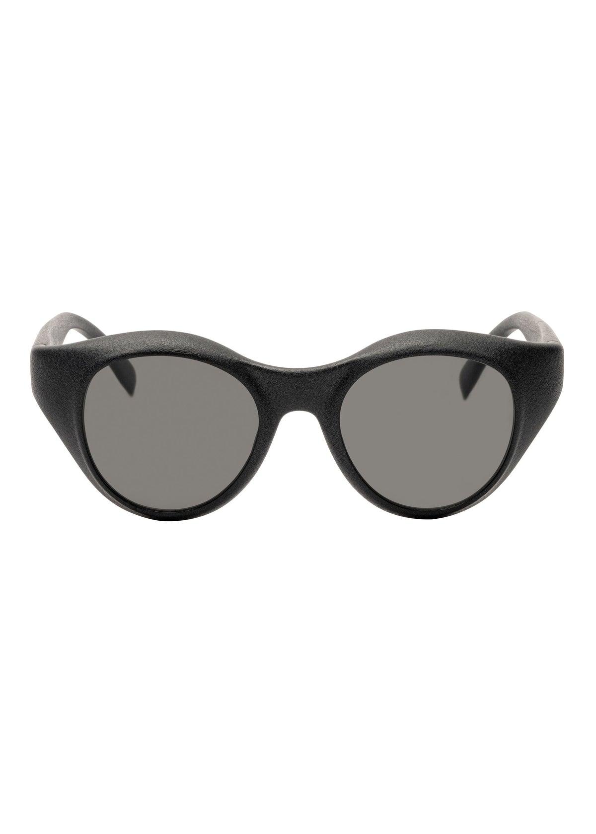 Front view of ISSEY MIYAKE EYES GRIT-BOSTON black Boston-style oval sunglasses with thick, rounded frames and dark tinted lenses against a white background. view 2 of 6