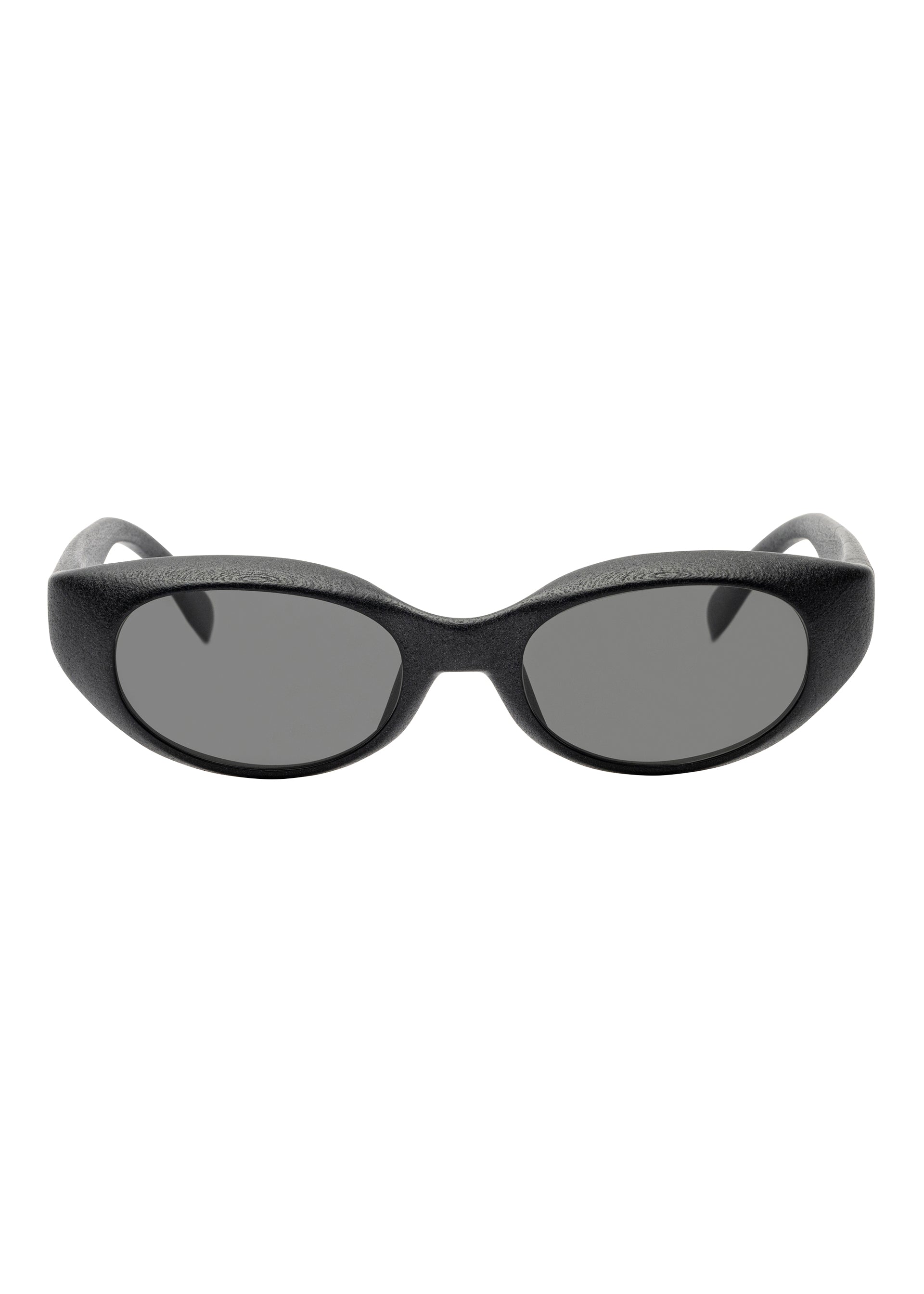 Zoomed view The ISSEY MIYAKE EYES GRIT-SQUARE sunglasses feature thick, textured black oval frames with dark tinted lenses, shown facing forward on a white background—a bold yet timeless statement piece.