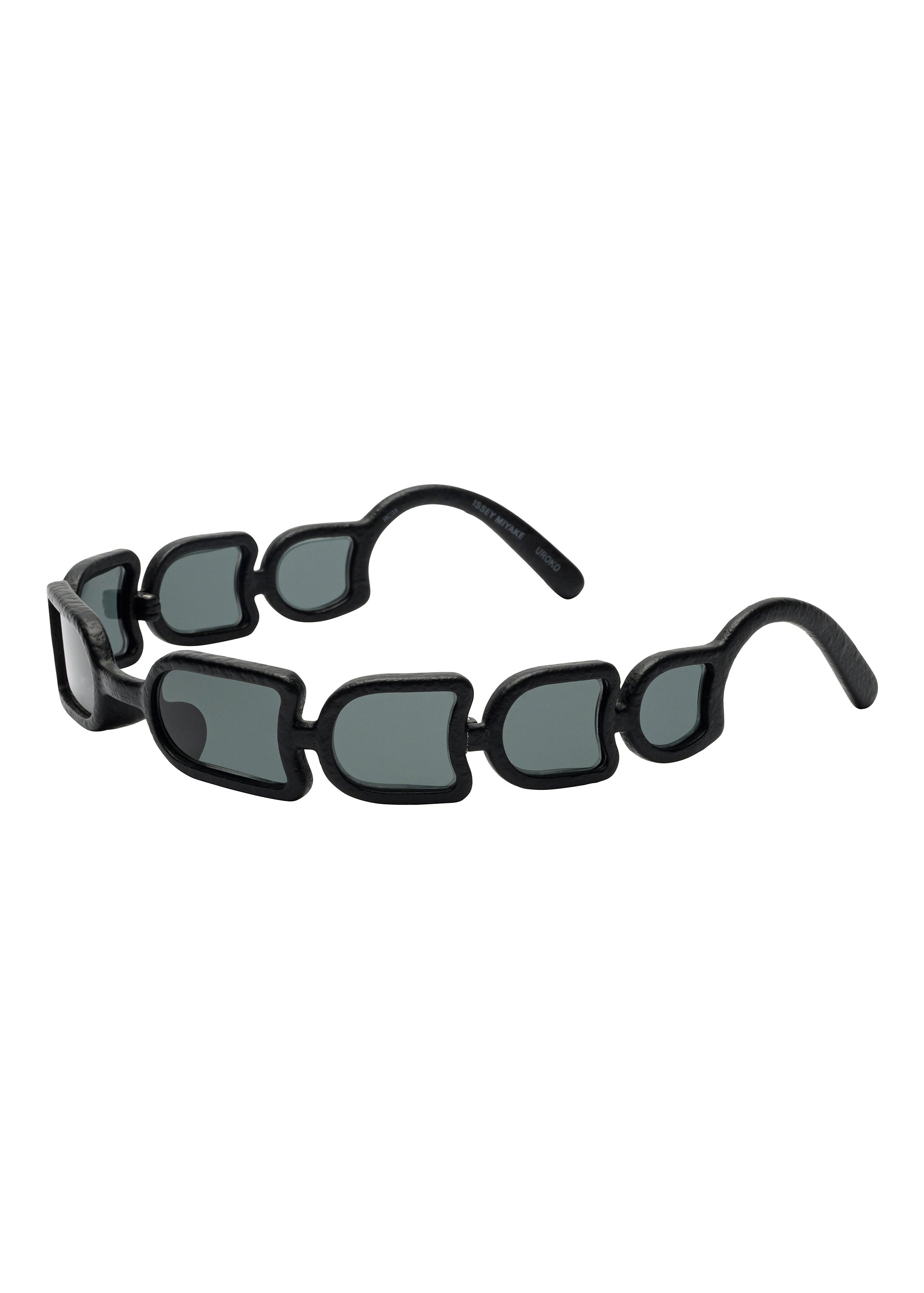 Zoomed view UROKO sunglasses by ISSEY MIYAKE EYES showcase Japanese craftsmanship with their unique design—multiple small, irregular dark lenses forming the frame and arms—displayed on a white background. - - (no.13)