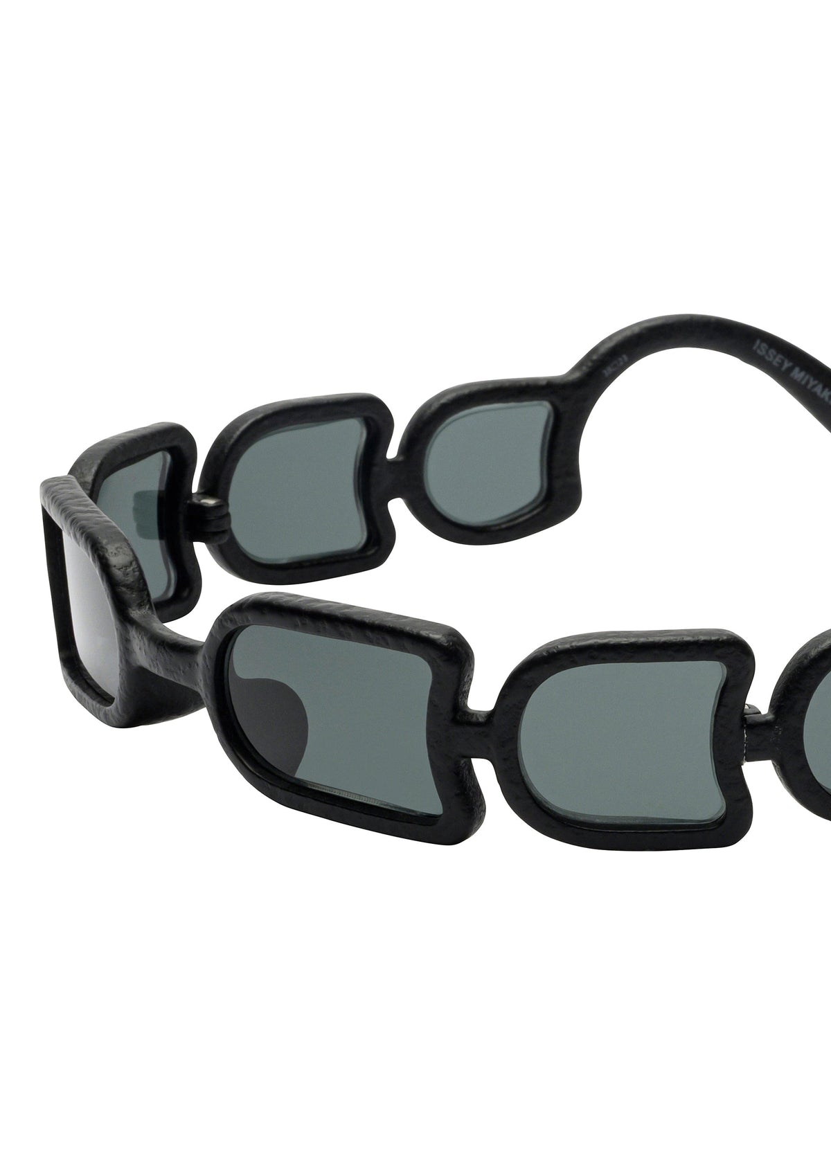 The UROKO sunglasses by ISSEY MIYAKE EYES feature a bold, chunky frame with geometric segments and dark-tinted rectangular lenses. Japanese-inspired craftsmanship creates a striking, statement accessory. view 3 of 5