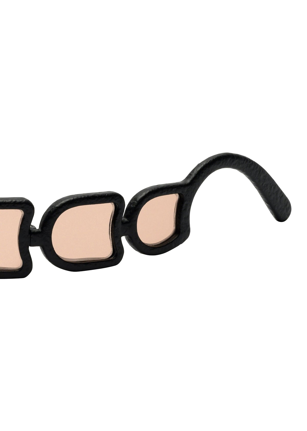 Close-up of the curved arm on ISSEY MIYAKE EYES UROKO sunglasses, featuring geometric shapes. The black frame with beige lenses highlights precise Japanese craftsmanship achieved via 3D printing. view 4 of 5