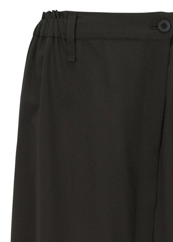 Close-up of the upper section of SEAMLESS BOTTOMS by 132 5. ISSEY MIYAKE, made from recycled polyester, featuring an elastic waistband, belt loop, button, and part of the leg for a relaxed silhouette. view 4 of 11