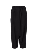 The SEAMLESS BOTTOMS by 132 5. ISSEY MIYAKE are black, loose-fit pants with an elastic waistband and draped, tapered legs, made from recycled polyester and shown on a white background. - Black (no. 15)