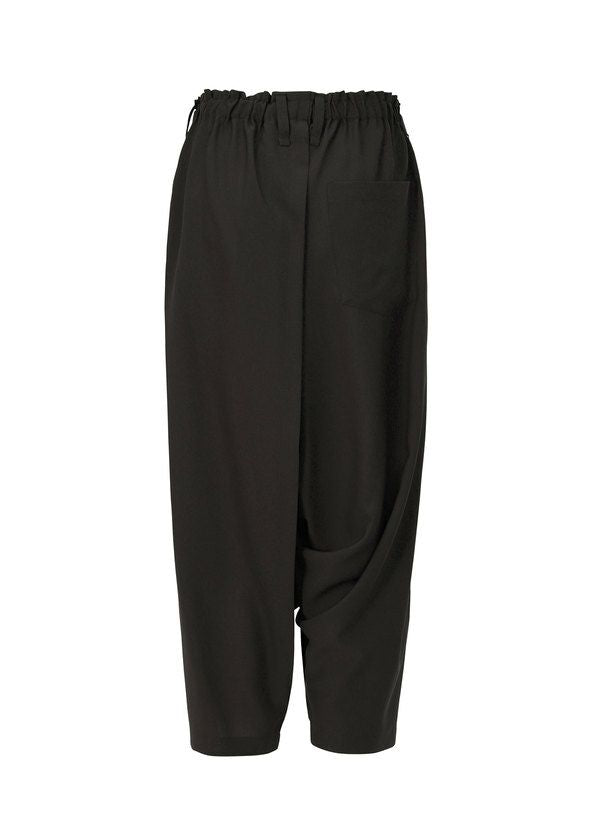 Zoomed view SEAMLESS BOTTOMS by 132 5. ISSEY MIYAKE are loose-fitting black sarouel pants with an elastic waist, cropped legs, and a right pocket. Made from soft recycled polyester, they feature a relaxed silhouette and gentle draping for casual style.
