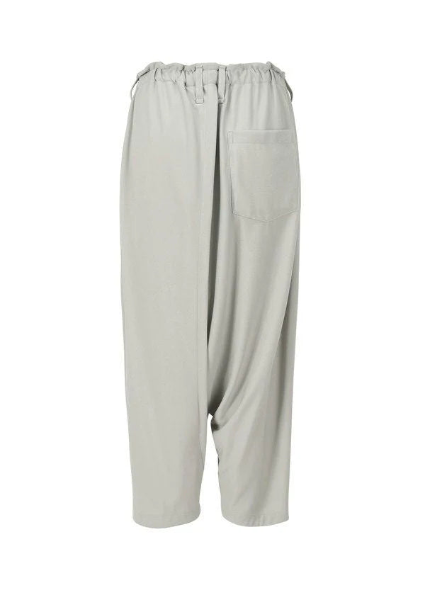 The JERSEY BOTTOMS BASIC by 132 5. ISSEY MIYAKE are light gray, loose sarouel pants featuring an elastic waistband, right front patch pocket, and a distinctive draped asymmetric design for a relaxed fit. view 3 of 11