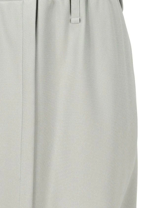 Close-up of light gray polyester fabric on the JERSEY BOTTOMS BASIC by 132 5. ISSEY MIYAKE, showing a waistband, belt loop, and vertical seam—details typical of this garment. view 6 of 11