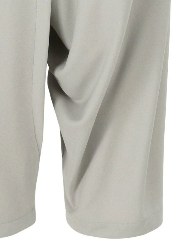 Zoomed view A close-up of JERSEY BOTTOMS BASIC by 132 5. ISSEY MIYAKE highlights the light gray color, relaxed silhouette, fabric drape, and seam details on the lower leg.