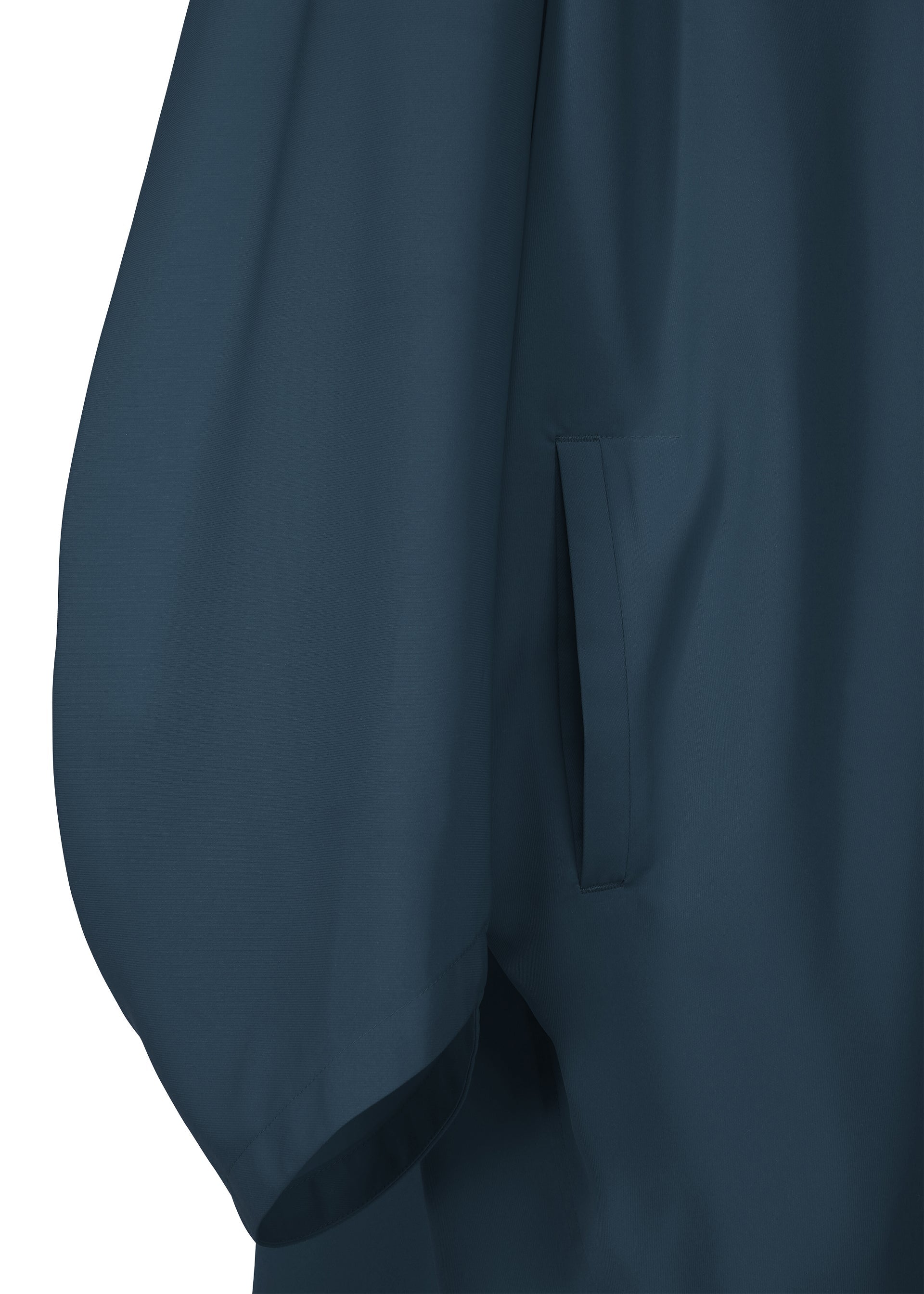 Zoomed view Close-up of the PARALLEL WRAP by 132 5. ISSEY MIYAKE in dark blue, showing a smooth, slightly shiny fabric with a side pocket and loose, flowing sleeve; only part of the lightweight coat is visible.