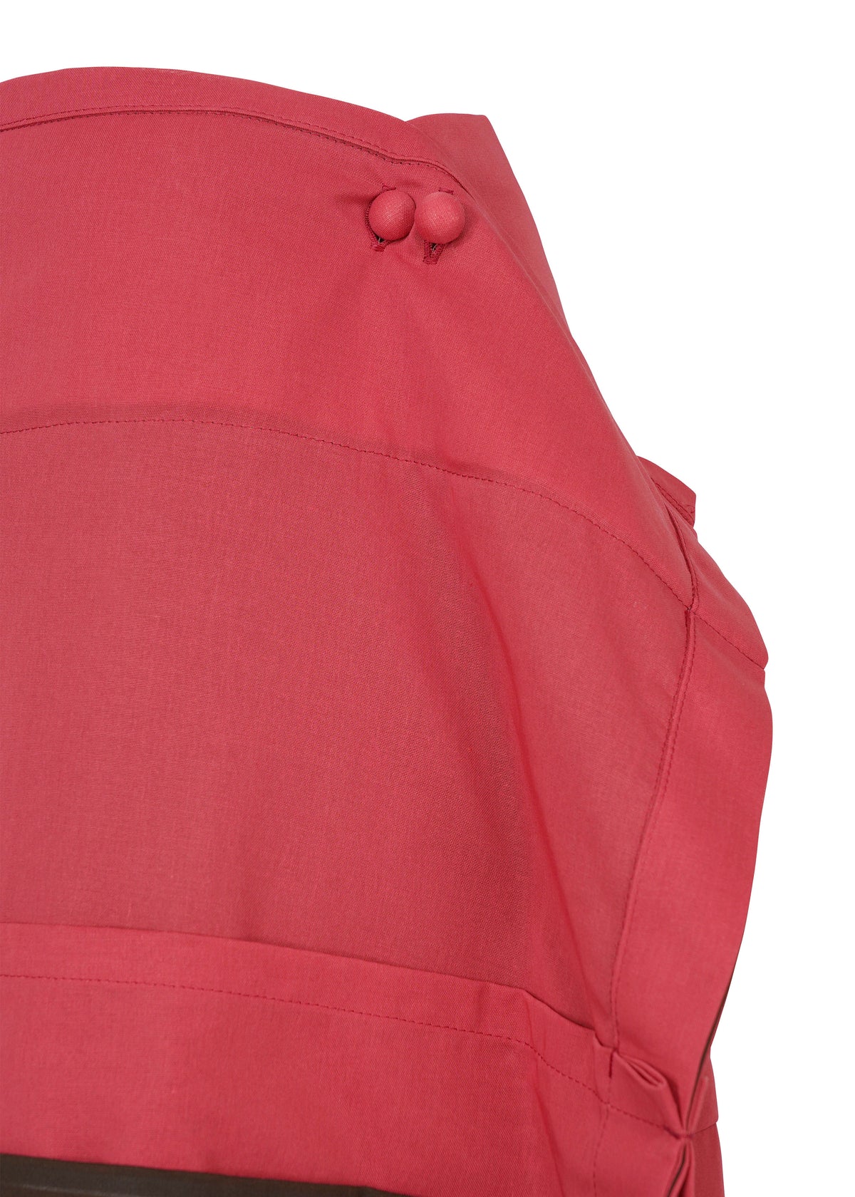 A close-up of the SHEER FOLIO by 132 5. ISSEY MIYAKE, a red garment with two fabric-covered shoulder buttons, visible stitching, and portfolio-inspired layered skirt design elements. view 4 of 11