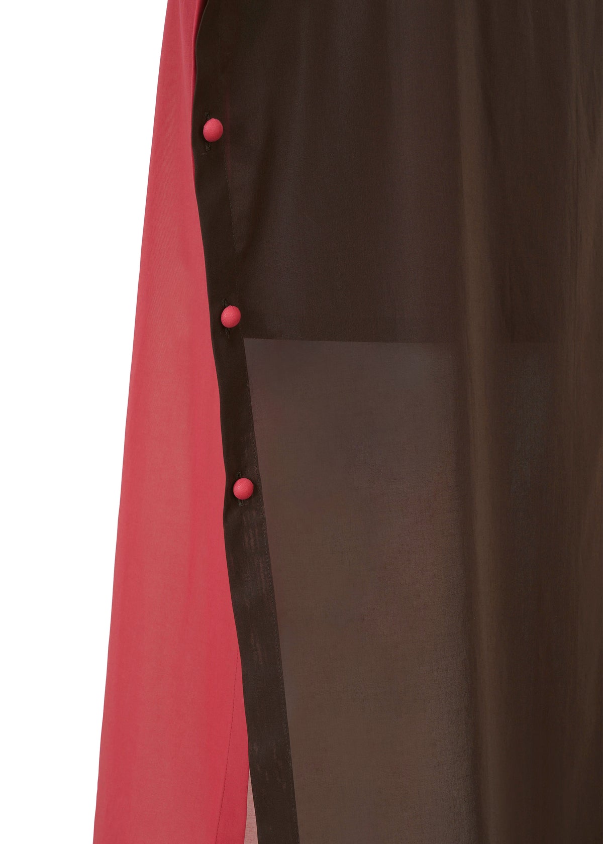 Close-up of the SHEER FOLIO by 132 5. ISSEY MIYAKE, showing a sheer black panel over solid pink fabric, layered like a skirt and secured with four round pink buttons along the seam. view 6 of 11