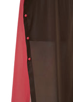 Close-up of the SHEER FOLIO by 132 5. ISSEY MIYAKE, showing a sheer black panel over solid pink fabric, layered like a skirt and secured with four round pink buttons along the seam.