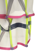 Close-up of NO.6 TRANSLUCENT by 132 5. ISSEY MIYAKE: sheer fabric with yellow, gray, and pink geometric stripes and pink trim. Soft drape highlights the folds and the delicate, translucent quality of the textile.