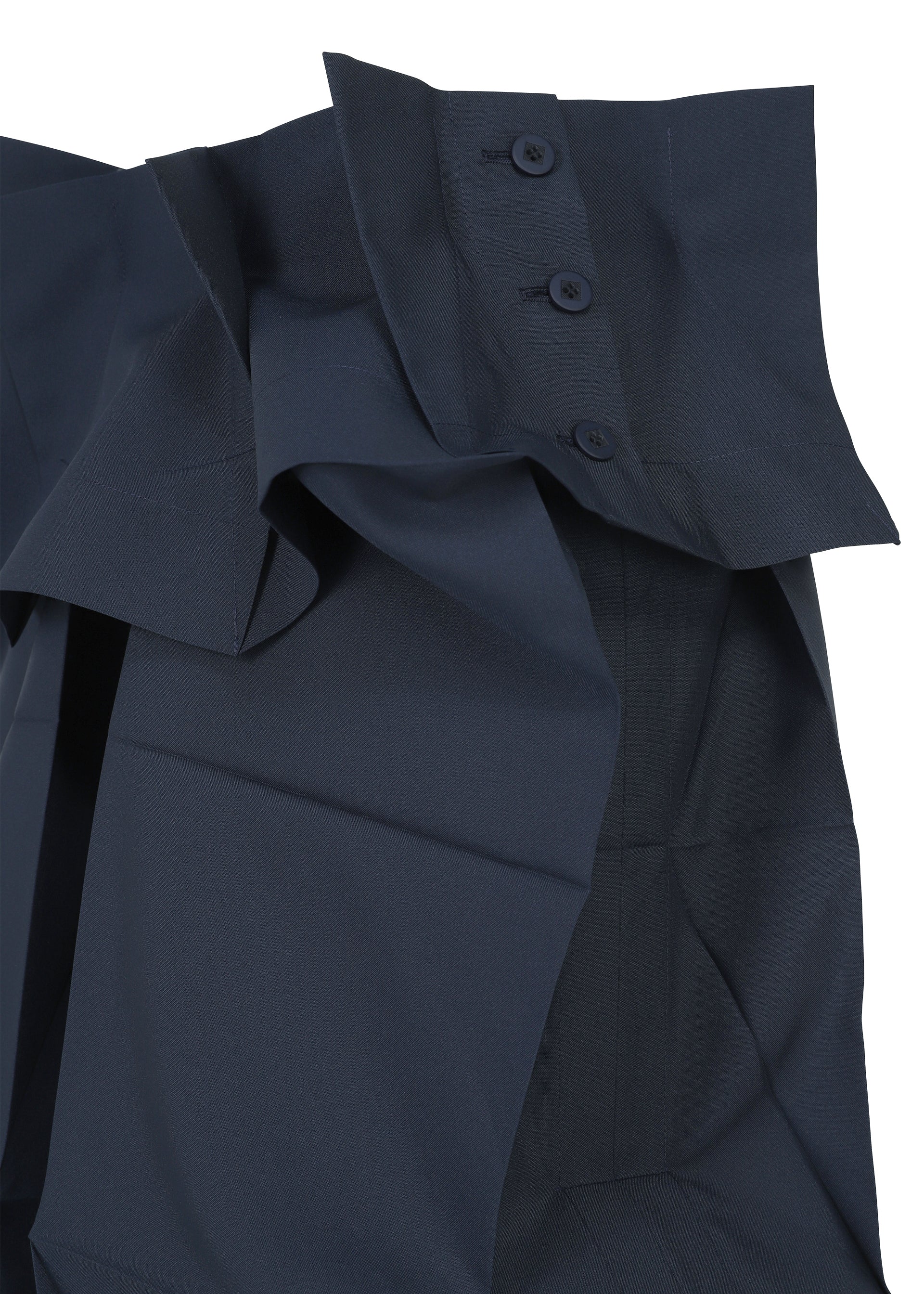 Zoomed view Close-up of the NO.6 SOLID by 132 5. ISSEY MIYAKE in dark blue, showcasing a structured, layered design with three dark buttons on a wide, folded collar and smooth, slightly shiny fabric emphasizing its unique three-dimensional form.