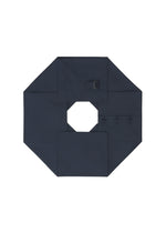 A dark navy blue NO.6 SOLID by 132 5. ISSEY MIYAKE is arranged octagonally with a hollow center, small buckle, three buttons, and visible seams on white, emphasizing its unique three-dimensional structure.
