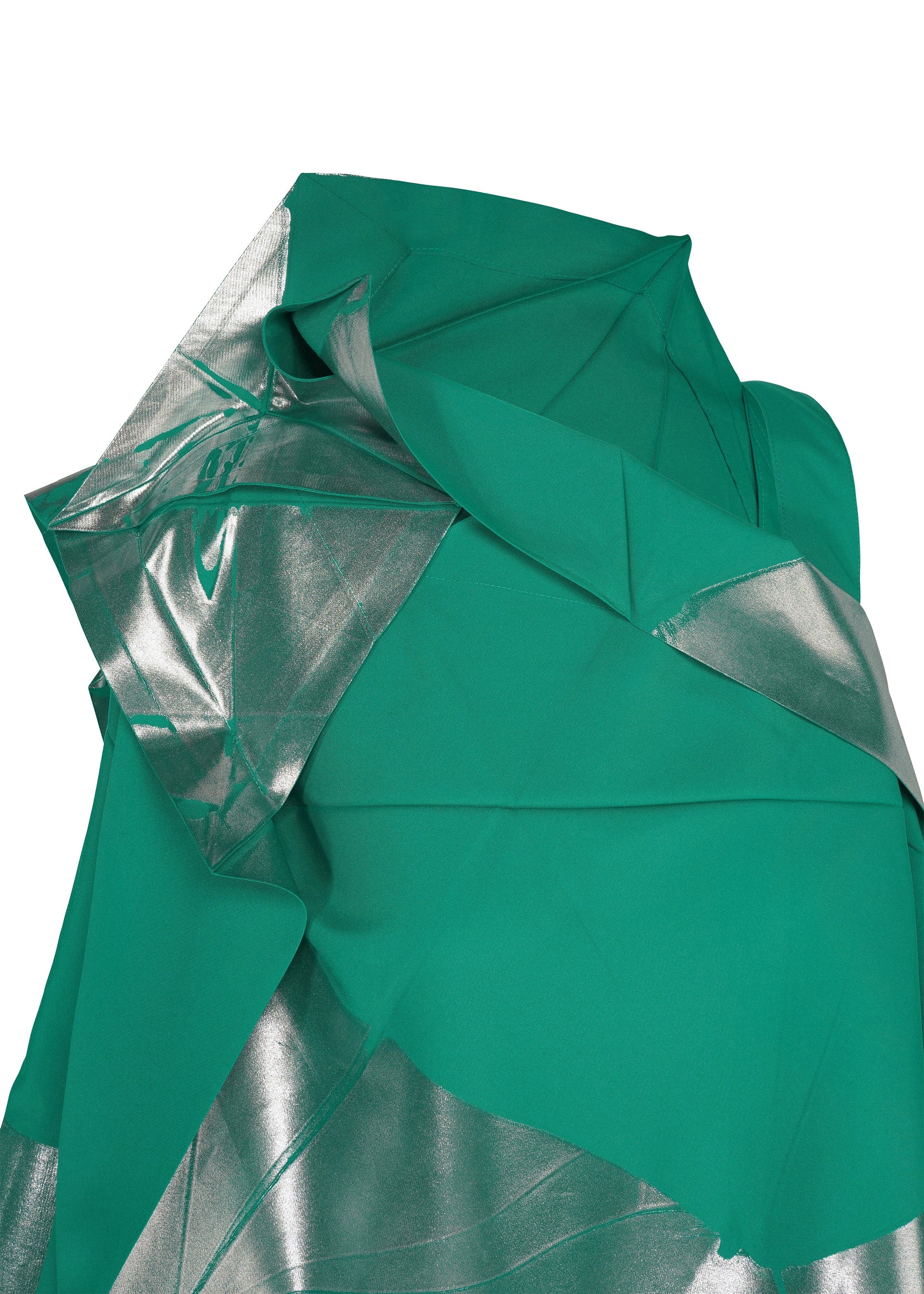 Zoomed view A close-up of NO.17 FOIL by 132 5. ISSEY MIYAKE shows green fabric with silver foil-transfer print, arranged in angular folds that evoke the brand’s innovative, three-dimensional dress silhouette.