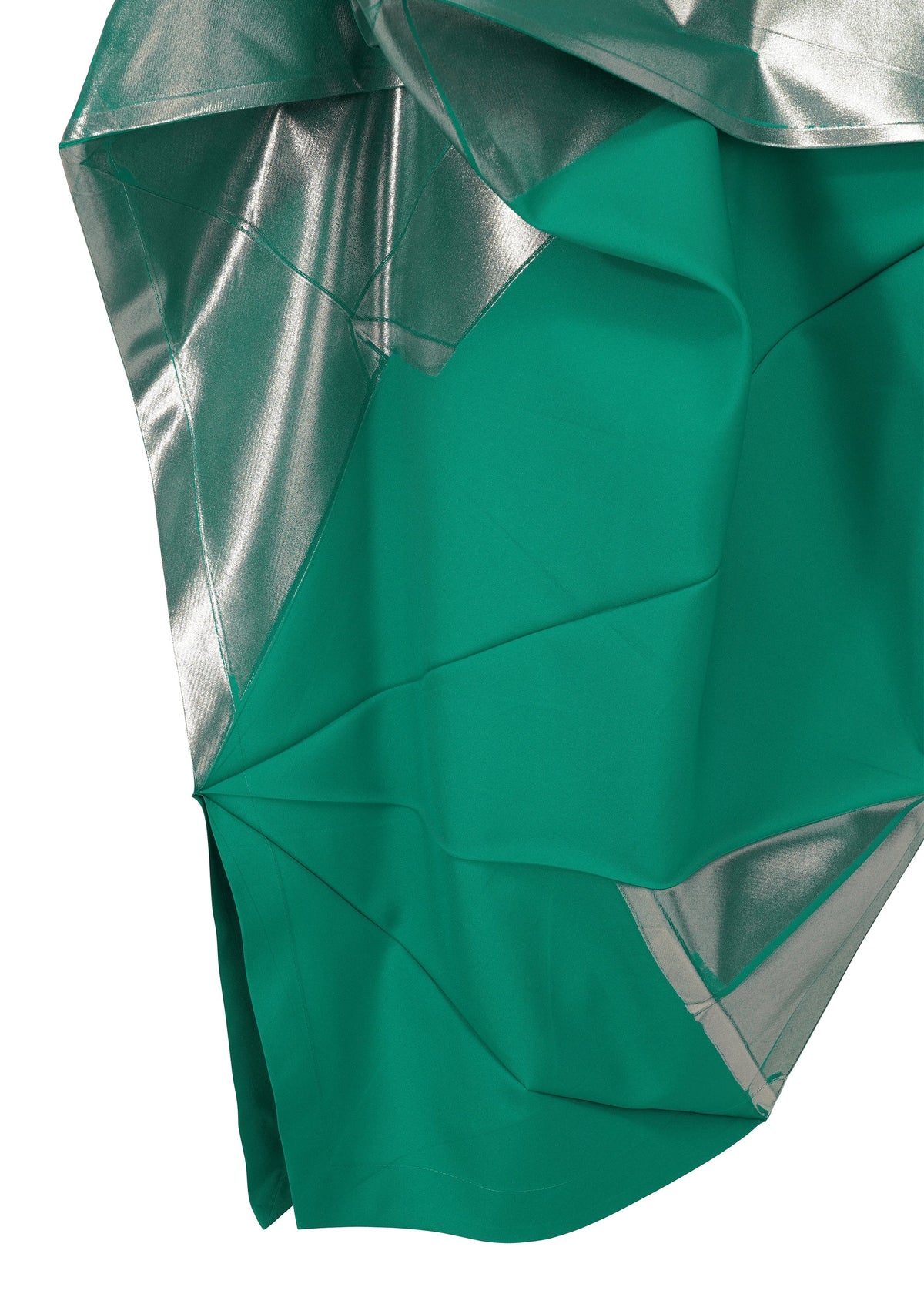 A close-up of NO.17 FOIL by 132 5. ISSEY MIYAKE shows green fabric with silver sections, sharp folds, and geometric lines that create an abstract, textured look inspired by innovative dress design. view 5 of 13