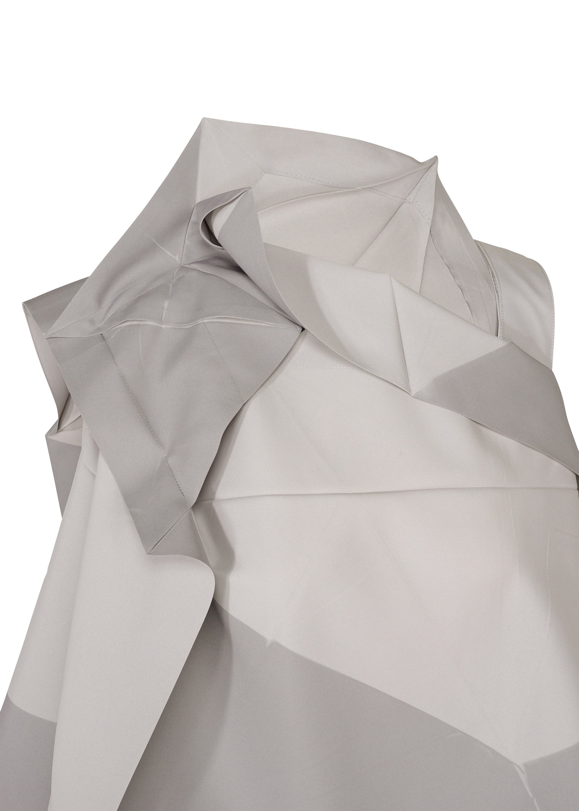 Zoomed view A close-up of light gray and white folded fabric from the NO.17 PRINT by 132 5. ISSEY MIYAKE, featuring sharp geometric patterns that echo the distinctive folding structure for a textured, abstract look inspired by innovative wearable design.