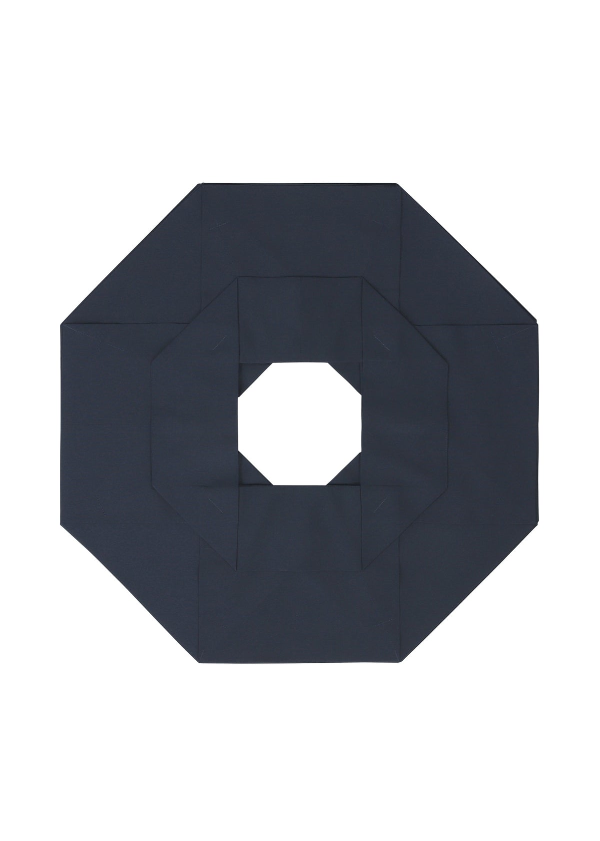 A geometric, dark-colored paper shape like an octagon with a square hole in the center, shown on white, recalls the three-dimensional style typical of 132 5. ISSEY MIYAKE’s NO.6 SOLID design. view 4 of 9