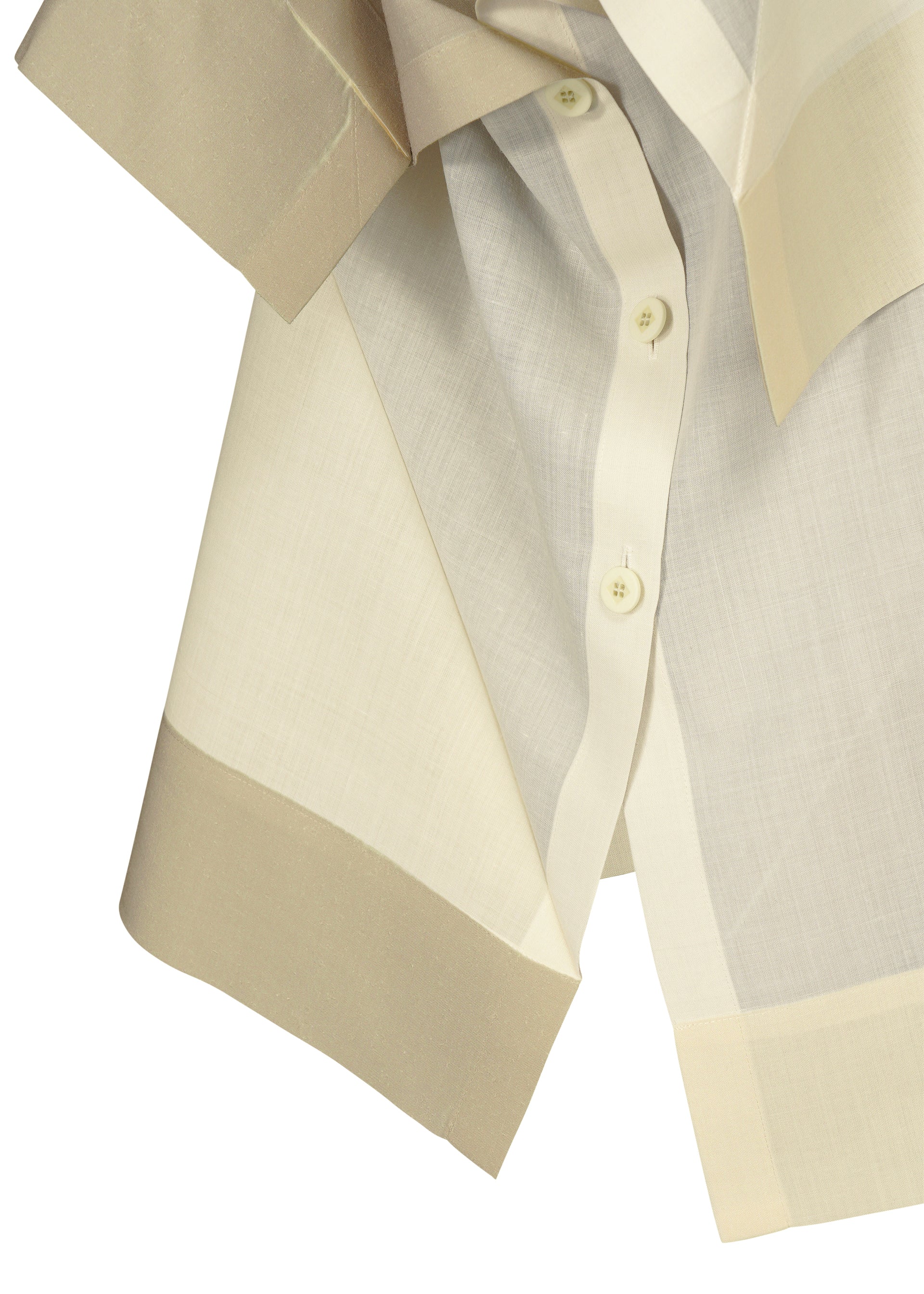 Zoomed view A close-up of the FOLD RAMIE PRINT by 132 5. ISSEY MIYAKE—a lightweight, cream and beige button-down shirt with sheer texture, subtle transfer print, wide cuffs, a collar, and visible white front buttons.