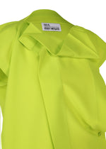 A close-up of a bright yellow-green FLAT TUCK T by 132 5. ISSEY MIYAKE, featuring structured folds and a visible brand label inside the collar, making a gorgeous impression.