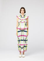 A woman stands facing forward in a NO.6 TRANSLUCENT outfit by 132 5. ISSEY MIYAKE, featuring bold plaid patterns in white, yellow, blue, and pink with ruffled accents and geometric folds. She wears white shoes and has short brown hair.