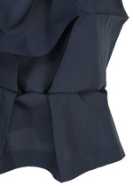 Close-up of the NO.6 SOLID by 132 5. ISSEY MIYAKE in navy, showcasing its crisp three-dimensional form with layered folds, clean seams, and precise tailored details.