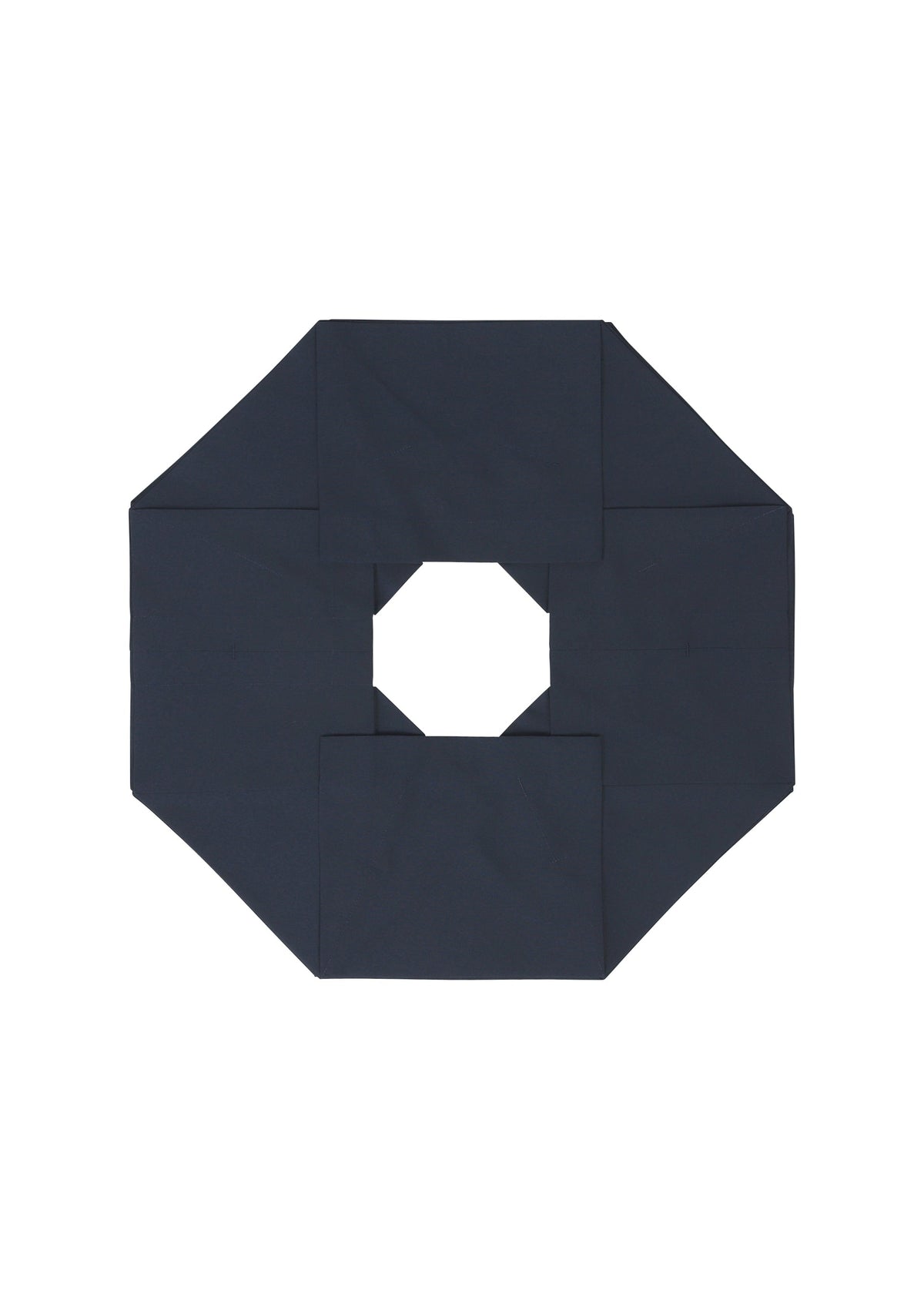 NO.6 SOLID by 132 5. ISSEY MIYAKE features a dark navy blue octagonal form with a central hole, folded to create a three-dimensional, symmetrical geometric design set against a white background. view 4 of 9