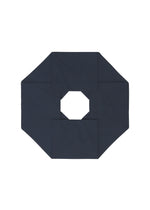 NO.6 SOLID by 132 5. ISSEY MIYAKE features a dark navy blue octagonal form with a central hole, folded to create a three-dimensional, symmetrical geometric design set against a white background.