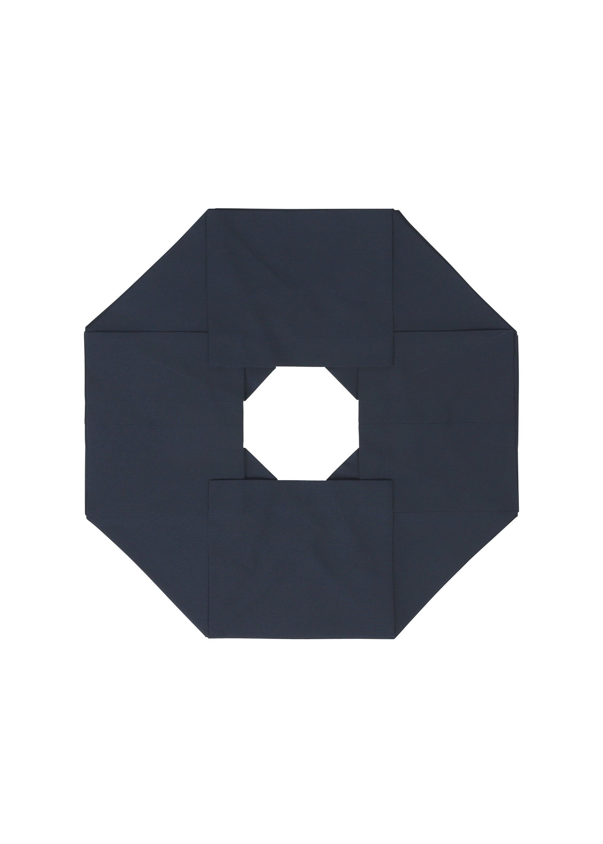 Zoomed view NO.6 SOLID by 132 5. ISSEY MIYAKE features a dark navy blue octagonal form with a central hole, folded to create a three-dimensional, symmetrical geometric design set against a white background.
