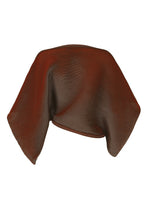 A red and black FACET KNIT scarf by 132 5. ISSEY MIYAKE drapes in fluid curves, highlighting its unique knit structure and deep folds against a plain white background.