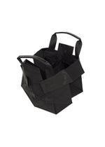 A black, geometric-shaped 132 5. STANDARD BAG by 132 5. ISSEY MIYAKE, featuring a foldable design with short handles and multiple exterior pockets, is displayed on a white background.