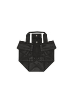 The 132 5. STANDARD BAG by 132 5. ISSEY MIYAKE, made from recycled polyester, showcases black geometric folds inspired by origami and foil designs. This foldable tote features two short handles and a button closure, elegantly presented against a white background.