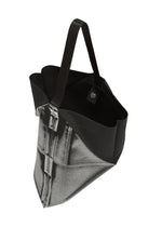The F-BG tote bag by 132 5. ISSEY MIYAKE is made from recycled polyester in black, showcasing a photographic denim jeans print, black handles, and an open top—presented from an angled overhead perspective.