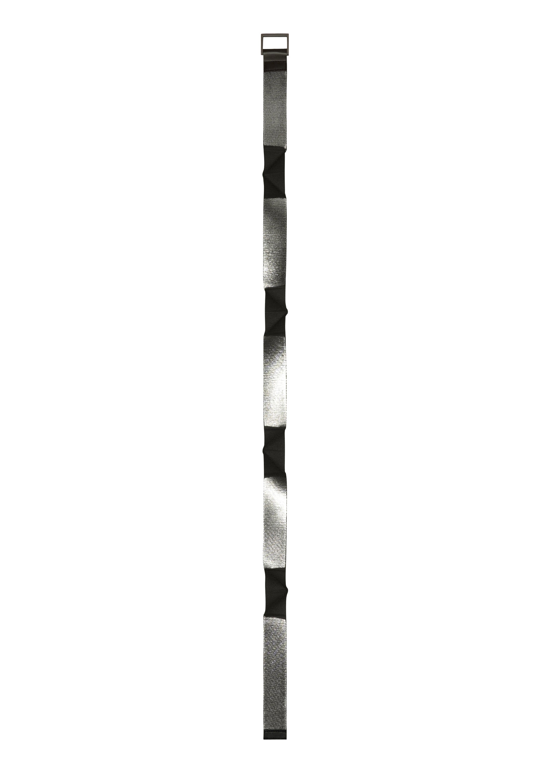 Zoomed view The F-BE by 132 5. ISSEY MIYAKE is a long, narrow, silver and black padded strap with rectangular segments and a unique shape, designed for carrying or securing items.
