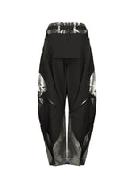 The F-BT pants by 132 5. ISSEY MIYAKE are high-waisted black recycled polyester trousers with a wide, sculptural silhouette, shiny metallic silver geometric panels, foil processing for angular details, belt loops, and a structured finish.