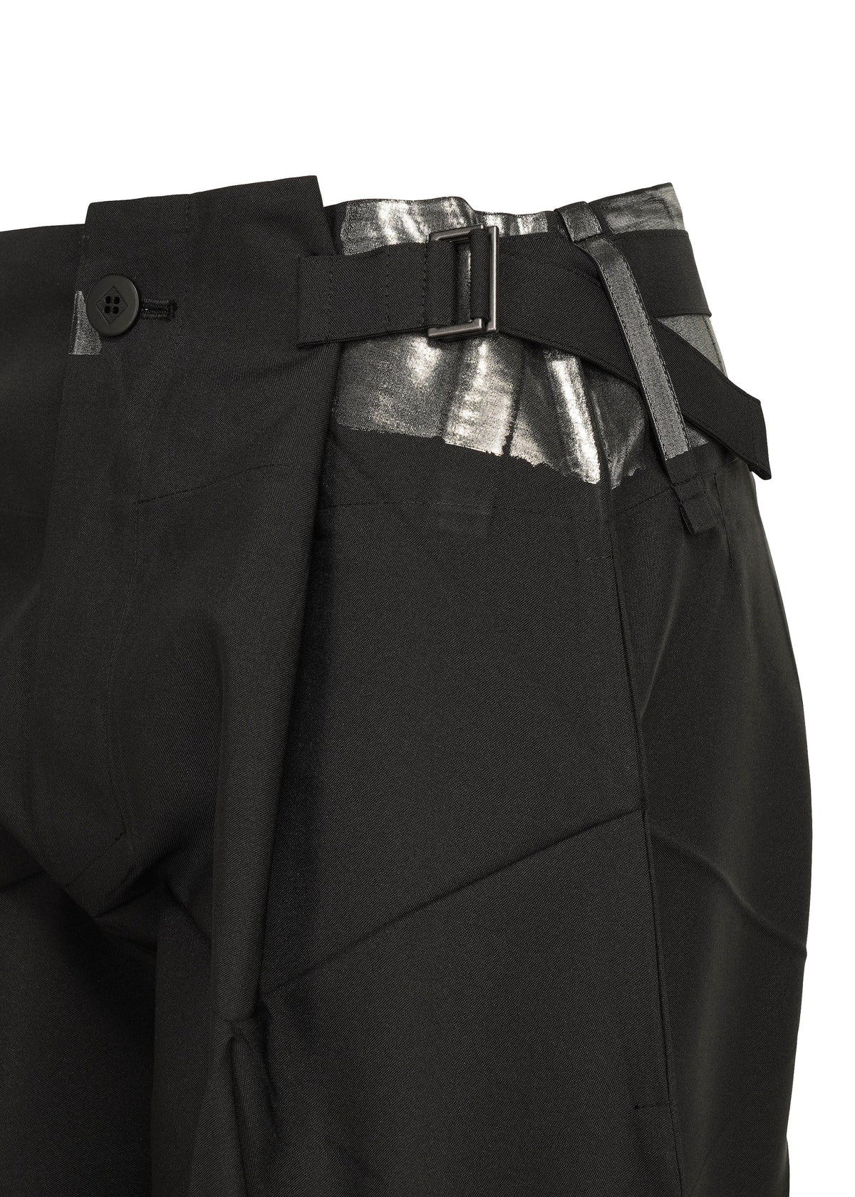 Close-up of the F-BT black tailored recycled polyester pants by 132 5. ISSEY MIYAKE, featuring a silver metallic waistband detail, foil processing, side buckle, and black button closure against a white background. view 6 of 13